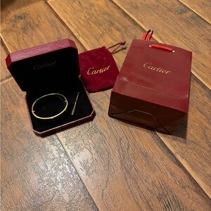 Cartier Gold Bangle with Red Accessories